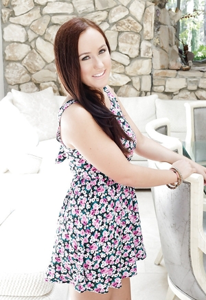 Young-looking girl with glamorous smile enters the house and furthermore takes off light summer dress