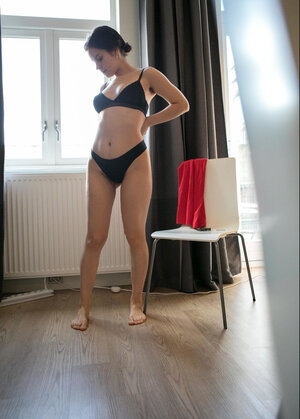 Rookie Daniela covers her natural bush with black panties and also puts on red dress