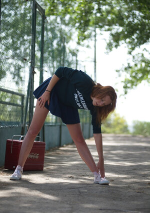 Hot red-haired cheerleader lifts skirt up to detect panties and nice butt