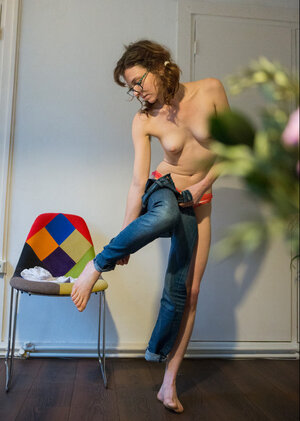 Skinny brunette hides her natural bush with cute panties and additionally pulls jeans on