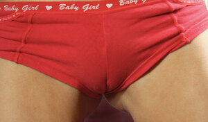 Delectable broad in below-the-knee socks poses for naked images on the couch