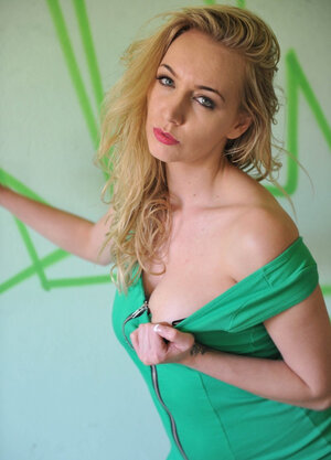 Sexy broad on heels erotically poses while unclothing in the abandoned building