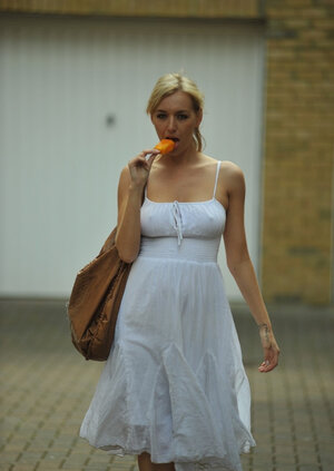 Hot blond beauty eats an ice cream while baring awesome bra buddies after long walk