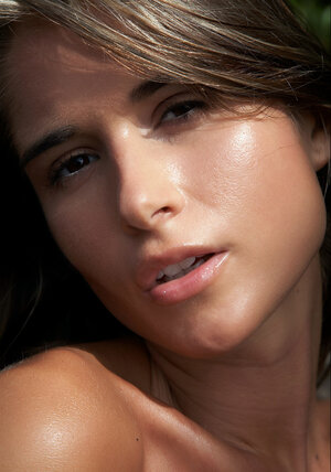 Seducing slim lady demonstrates her big titties for erotic session on the beach