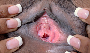 Tempting immature black woman with a wide smile enjoys attention to her vagina