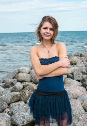 European chick starts with natural jugs and then goes to honey pot on the stony beach