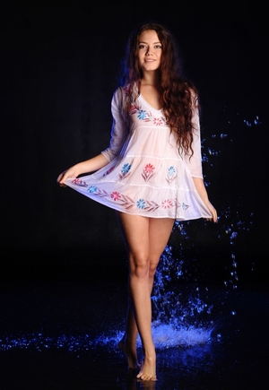 Joyful European sexpot covered in water while posing completely naked