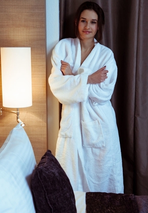 Broad enters bedroom after bathing and also takes off white robe showing skinny body