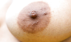 Whitney the aroused babe is petting her black vagina in a field