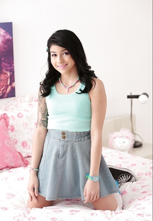 Tiny Latina smiles sweetly getting naked down and closes eyes when touches vag