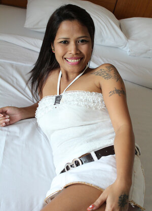 Thai girl shows the outline of her meaty cunt in a skirt number one