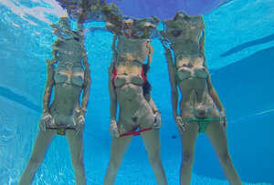 Three sweet models shake their bare asses in the swimming pool