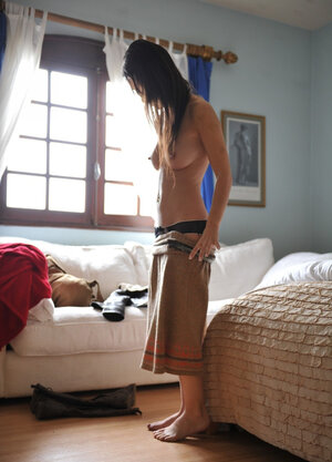 Brunette beauty Jess West casually disrobes and additionally stand additionallys naked in the living room