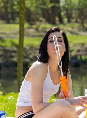 Hot brunette gal enjoys an old man fucking her in the park