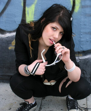 Fetish doll spreads legs and moreover poses naked in alleyway with sunglasses