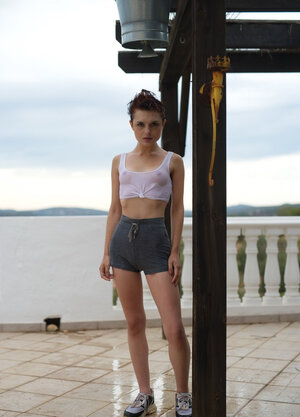 Short red-haired babe with freckles smokes after getting dripping wet