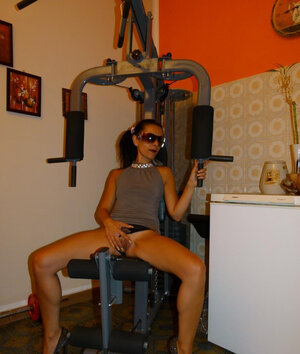 Tanned lady wearing sunglasses while filming the action