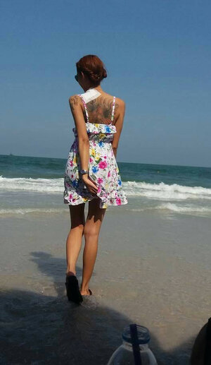 Oriental brunette with sexy tattoos snapping numerous hot pictures