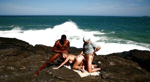 Bigtitted blonde MILF double penetrated on rocky coast by white and black fellas