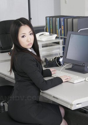 Pretty Oriental office chick in black stockings is ready to show off hirsute pussy