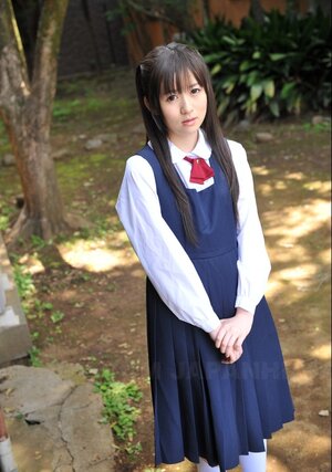 Innocent Japanese schoolgirl with nice-looking eyes walks seductively under sun