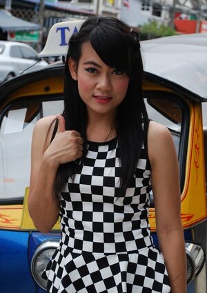 Inviting Thai porn model in a checkered dress gets into the Tuk Tuk Taxi