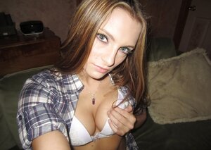 Gal shows off her shaved cunt and boobs on camera that she holds in hands