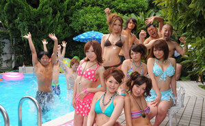 Asian girlfriends in skimpy bikinis rest half-naked with men poolside