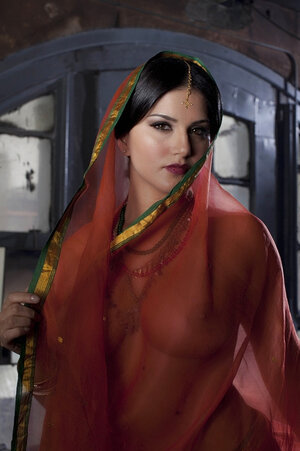 Diva in a transparent red sari fails to hide her large melons with dark nipples