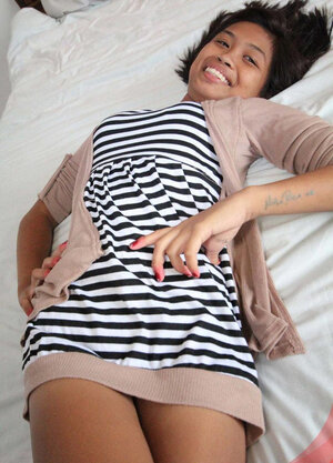 Glamorous Asian broad takes off a striped dress in exchange for some money