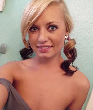 Playful gal makes erotic selfies showing off her naked body in the bathroom