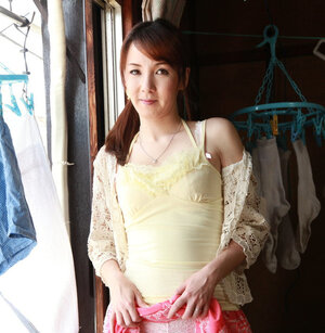 Red-haired Japanese housewife performs terrific strip show near window