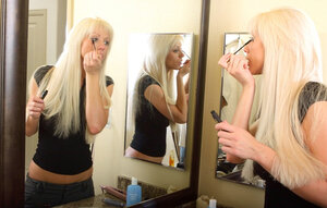 Blonde adult actress with milk sacks shows how she prepares for a day of work