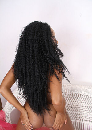 Black girl in high heels airs her butt cheeks and besides shows what she has between legs