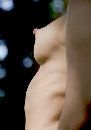 Platinum blonde beautiful thing in black stockings strips naked in the fresh air