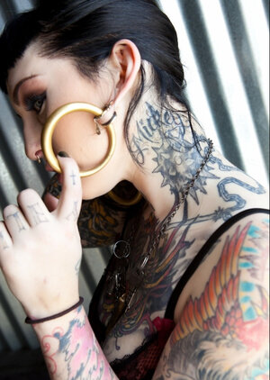 Tattooed brunette with hoop earrings shows how her smooth cum bucket looks like