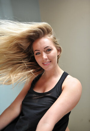 Awesome nympho flaunts her huge breasts and round booty by the window