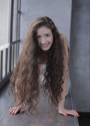 Long-haired brunette Flo climbs windowsill to relax there like a undressed nymph