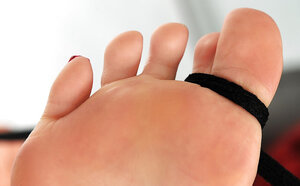 Red-haired Asiatic gal removes fishnets and moreover teases with her feet and moreover toes